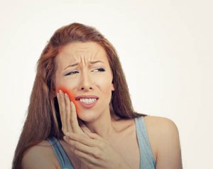 'woman in pain after wisdom tooth removal'