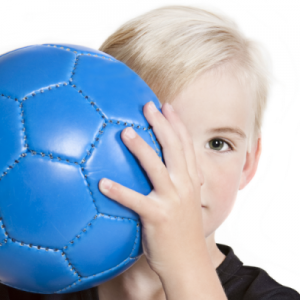 'child holding soccer ball'