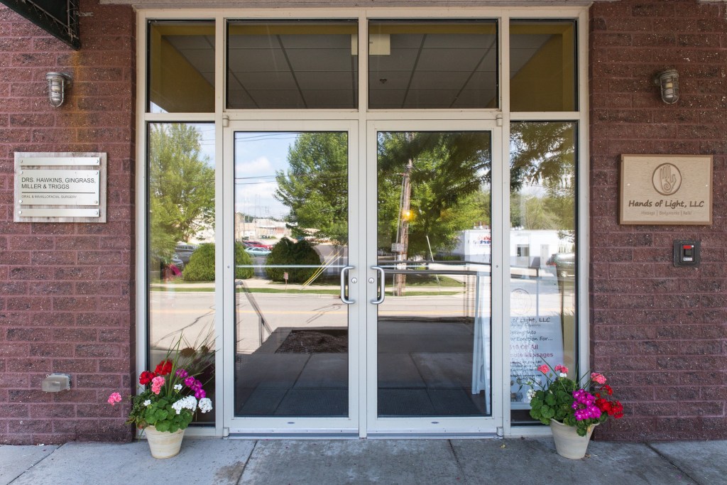 Outside office building - door swinging glass