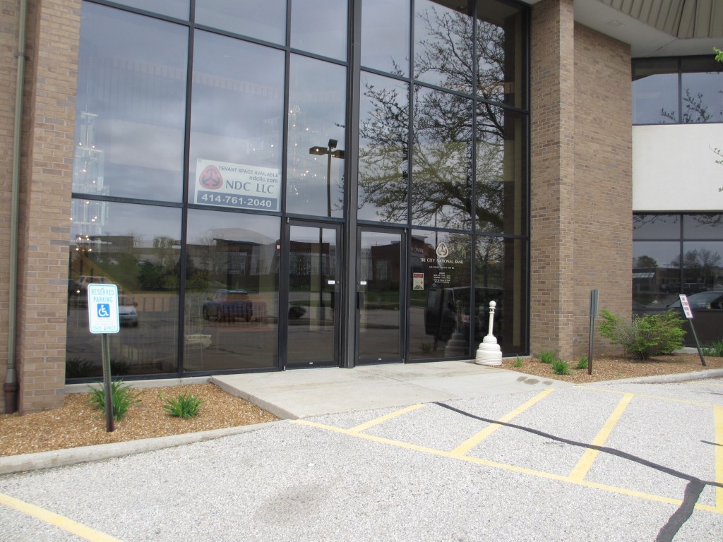 Outside of office building, with large glass doors